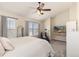 Vaulted ceiling in main bedroom featuring a ceiling fan, television, and plush carpeting at 22725 E Ottawa Pl, Aurora, CO 80016