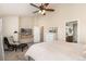 Spacious bedroom with a fan, TV, sitting area, and ensuite bathroom at 22725 E Ottawa Pl, Aurora, CO 80016