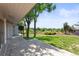 A patio with a view of a lush green lawn and mature trees with a house on the left at 4 Greenridge Rd, Greenwood Village, CO 80111