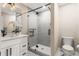 Modern bathroom featuring a frameless glass shower, a white vanity, and a stylish light fixture at 4 Greenridge Rd, Greenwood Village, CO 80111