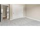 A bright bedroom features plush gray carpet and a closet with sliding doors at 4 Greenridge Rd, Greenwood Village, CO 80111