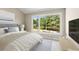 Serene bedroom with large windows offering views of lush greenery, and comfortable decor at 4 Greenridge Rd, Greenwood Village, CO 80111