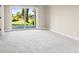 Empty bedroom with plush carpeting and sliding glass doors to the backyard and sunny patio at 4 Greenridge Rd, Greenwood Village, CO 80111