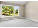 A cozy bedroom with a large window that overlooks a peaceful outdoor view at 4 Greenridge Rd, Greenwood Village, CO 80111