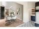 Open-concept dining area with a glass table, modern chairs, and access to the kitchen at 4 Greenridge Rd, Greenwood Village, CO 80111