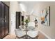 Bright dining area with a glass table, modern chairs, and black storage cabinets at 4 Greenridge Rd, Greenwood Village, CO 80111