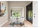Bright dining area with a glass table, modern chairs, and black storage cabinets at 4 Greenridge Rd, Greenwood Village, CO 80111