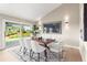 Bright dining area with modern lighting and a sliding glass door offering picturesque backyard views at 4 Greenridge Rd, Greenwood Village, CO 80111
