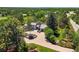 Stunning home with lush landscaping, circular brick driveway, and mature trees at 4 Greenridge Rd, Greenwood Village, CO 80111