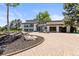 Modern home featuring a brick driveway, large windows, and a two-car garage at 4 Greenridge Rd, Greenwood Village, CO 80111