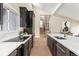 Modern kitchen boasts black cabinets, stainless steel appliances, and a stylish island with a sleek design at 4 Greenridge Rd, Greenwood Village, CO 80111