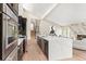 Open concept kitchen with modern appliances, a large island, and seamless flow to the living area with fireplace at 4 Greenridge Rd, Greenwood Village, CO 80111