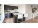 Modern kitchen with sleek black cabinetry, a wine fridge, and seating for two at 4 Greenridge Rd, Greenwood Village, CO 80111