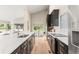 Modern kitchen featuring a waterfall island, stainless steel appliances, and a view of the backyard at 4 Greenridge Rd, Greenwood Village, CO 80111
