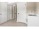 A laundry room featuring white cabinets, a sink, and access to multiple rooms with neutral paint at 4 Greenridge Rd, Greenwood Village, CO 80111