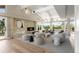 Bright living room with a stone fireplace, high ceilings, and a wall of windows at 4 Greenridge Rd, Greenwood Village, CO 80111