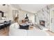 Spacious living room features a modern fireplace and flows into the kitchen, perfect for entertaining at 4 Greenridge Rd, Greenwood Village, CO 80111
