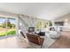 Living room boasts a marble fireplace, an open floorplan, and backyard views through walls of windows at 4 Greenridge Rd, Greenwood Village, CO 80111