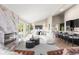 Open concept living space with a modern fireplace, kitchen, and dining area for seamless entertaining at 4 Greenridge Rd, Greenwood Village, CO 80111