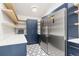 Well-organized pantry with custom shelving, cabinets, and a stainless steel refrigerator at 4 Greenridge Rd, Greenwood Village, CO 80111