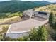 Aerial view of a home with solar panels, a large driveway, and scenic mountain views at 18844 Ute Vista Trl, Morrison, CO 80465