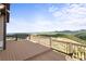 Enjoy breathtaking panoramic views from the expansive wooden deck, perfect for outdoor living at 18844 Ute Vista Trl, Morrison, CO 80465