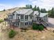 Spacious home featuring a metal roof, multiple decks, and large windows offering stunning views at 18844 Ute Vista Trl, Morrison, CO 80465