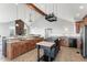 Bright kitchen featuring granite counters, custom cabinetry, and views of the landscape through large windows at 18844 Ute Vista Trl, Morrison, CO 80465