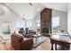 Spacious living room featuring a fireplace, large windows with mountain views, and vaulted ceilings at 18844 Ute Vista Trl, Morrison, CO 80465