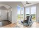 Bright living room featuring large windows with mountain views, vaulted ceiling, and hardwood floors at 18844 Ute Vista Trl, Morrison, CO 80465