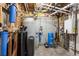 Basement utility room featuring extensive mechanical equipment, including water tanks and plumbing systems at 18844 Ute Vista Trl, Morrison, CO 80465