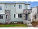 Stylish townhome featuring blue siding, stone accents, and a welcoming front porch entry at 14109 Deertrack Ln, Parker, CO 80134