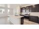 Bright kitchen with dark cabinetry, stainless steel appliances, and a large island at 14109 Deertrack Ln, Parker, CO 80134