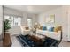 Inviting living room featuring a white sofa, accent pillows, and natural light at 14109 Deertrack Ln, Parker, CO 80134