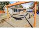 Expansive backyard featuring a hammock, hot tub, deck and an detached garage with colorful outdoor seating at 951 S Fulton St, Aurora, CO 80247