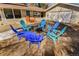 Spacious backyard featuring colorful chairs centered around a fire pit, perfect for relaxation at 951 S Fulton St, Aurora, CO 80247