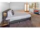 Bedroom with comfortable carpet, natural light, and a view of the outside greenery at 951 S Fulton St, Aurora, CO 80247