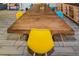 Long wooden dining table surrounded by colorful chairs in a spacious room at 951 S Fulton St, Aurora, CO 80247