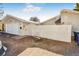 Exterior shot of the property featuring a one car garage, gate, and green trash can at 951 S Fulton St, Aurora, CO 80247