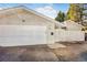 View of detached one car garage with white wooden door, and house number 951 at 951 S Fulton St, Aurora, CO 80247