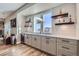 Basement bar with wet bar, custom cabinets and window at 229 High Meadows Loop, Elizabeth, CO 80107