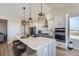 Modern kitchen with white cabinets, quartz countertops, and island at 229 High Meadows Loop, Elizabeth, CO 80107