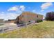 Spacious backyard with a white fence, a deck, and mature landscaping at 38087 E 147Th Pl, Keenesburg, CO 80643