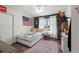 Bedroom with American flag, nice window and wood-look floors at 38087 E 147Th Pl, Keenesburg, CO 80643