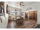 Stylish dining area with wood floors, ample seating, and barn door at 38087 E 147Th Pl, Keenesburg, CO 80643
