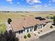 An aerial view shows the home's landscaped yard, solar panels, and white picket fence at 38087 E 147Th Pl, Keenesburg, CO 80643