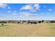 A view of the expansive backyard and patio area is showcased in this aerial view at 38087 E 147Th Pl, Keenesburg, CO 80643
