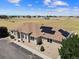 Charming home featuring well-kept landscaping, a welcoming entrance, and solar panels for energy efficiency at 38087 E 147Th Pl, Keenesburg, CO 80643