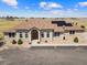 Inviting front exterior of a well-maintained home with landscaping, a circular driveway, and a welcoming entrance at 38087 E 147Th Pl, Keenesburg, CO 80643