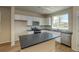 Kitchen featuring an island, white cabinetry, granite countertops, and stainless steel appliances at 23951 E 40Th Ave, Aurora, CO 80019